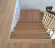 After sanding and hand scraping wood flooring, stair treads, and landings