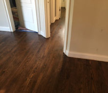 Sanded, stained, and refinished red oak plank flooring