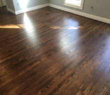 Sanded, stained, and refinished red oak plank flooring