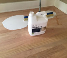 Applying Bona NordicSeal to sanded red oak wood flooring