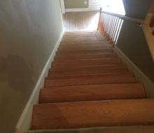 Whitewashed refinished wooden stair treads and red oak wood flooring.