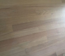 Whitewashed refinished red oak wood flooring.