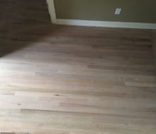 Whitewashed refinished red oak wood flooring.