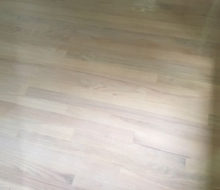 Whitewashed refinished red oak wood flooring.