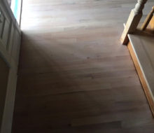 Whitewashed refinished red oak wood flooring and stair treads.