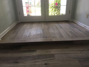 Hickory wood look floor tile installed - elevated floor/step