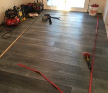 Strapped beachy look White Oak flooring being installed