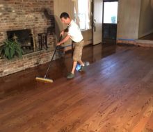 Applying finish to solid red oak plank flooring with walnut pegs