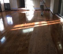 Applying finish to solid red oak plank flooring with walnut pegs