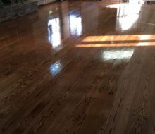 Applying finish to solid red oak plank flooring with walnut pegs