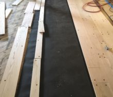 Red oak planks with walnut pegs being installed