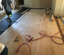 Red oak planks with walnut pegs being installed