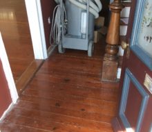 More water damaged old heart pine plank flooring - hallway