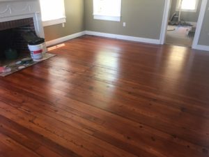Refinished and restored old heart pine plank flooring