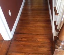 Refinished and restored old heart pine plank flooring - hallway