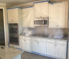 Sealing cabinets and appliances with plastic film during tile removal