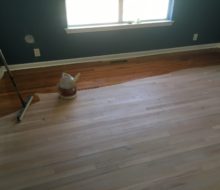 Applying finish to sanded solid red oak clear grade flooring