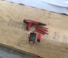 Nail gun for plywood to concrete slab