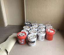 Buckets of removed condo tile