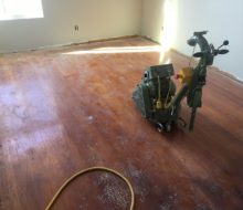 Lager-Hummel Belt Sanding Machine on solid red oak flooring - before