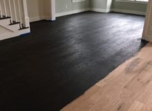 Applying stain to grain popped, sanded red oak flooring