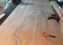 Installing drilled red oak planks with nickels for expansion