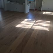 Installed wire brushed white oak wood flooring