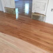 Applying sealer to solid red oak flooring