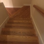 Refinished wooden staircase, rail, and landing