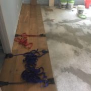 Flooring straps used while installing wide white oak flooring