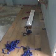 Flooring straps used while installing wide white oak flooring