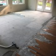 Preparing concrete slab for wood flooring installation - showing drop at rear wall