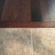 Header board between new engineered Hickory hardwood flooring and tile