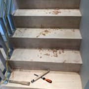 Sanding and hand scraping stairway