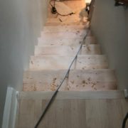 Sanding and hand scraping stairway