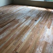 Popping grain of sanded Red Oak flooring