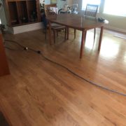 Prior to sanding, staining and refinishing the existing wood floors.