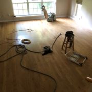 Prior to sanding, staining and refinishing the existing wood floors.