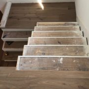 Installing engineered White Oak hardwood flooring stair treads.