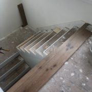 Installing engineered White Oak hardwood flooring stair treads.