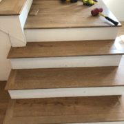 Installing engineered White Oak hardwood flooring stair treads.