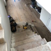 Installing engineered White Oak hardwood flooring stair treads.