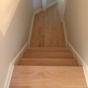 Sanded, hand scraped Red Oak floors and stair treads.