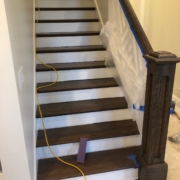 Staining the newel post and hand railing.