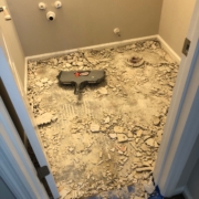 Removing bathroom flooring.