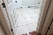 White tile laundry room floor.