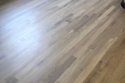 Sanding solid White Oak flooring.
