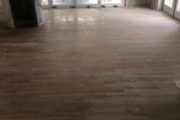Sanding solid White Oak flooring.