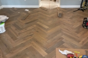 Installing French Oak flooring in the herringbone pattern.