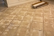 Grinding tile flooring.